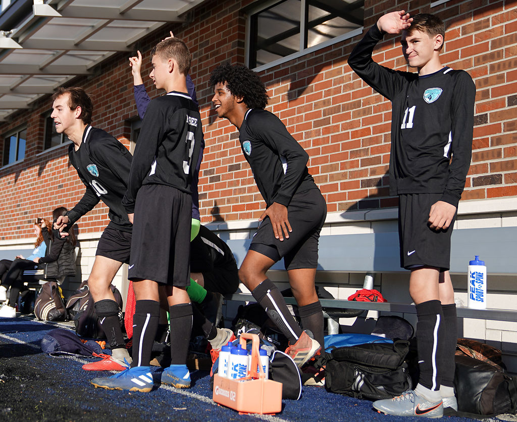 From left, Holden Petri (10), Luke McBee (3), Lael Haile (9) and Jacob Barr (11) of Tolton Catholic High School celebrate after their team defeated Lutheran North High School